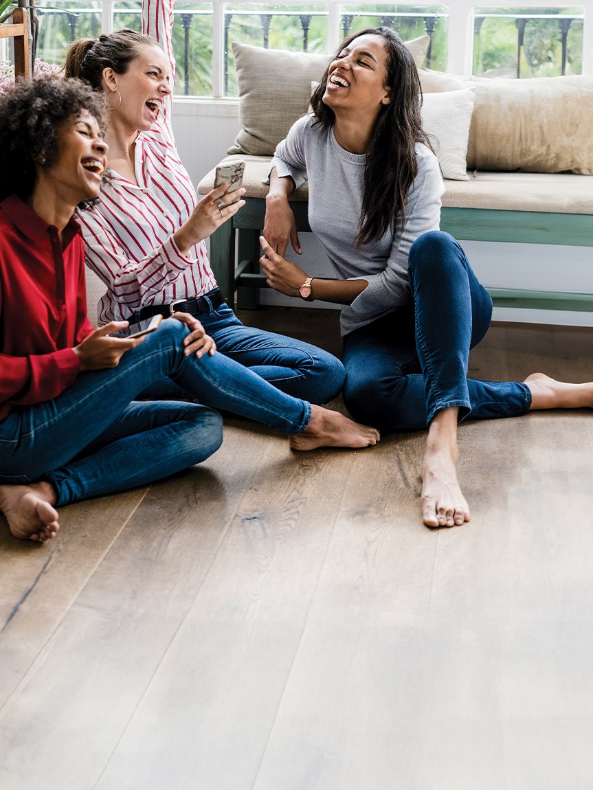 Mom and daughter playing with tablet on hard surface floors